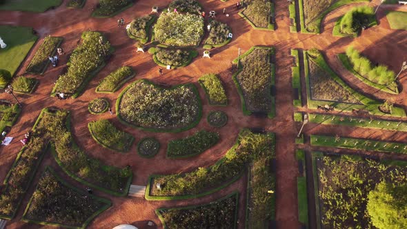 People in Rosedal or rose garden, Tres de Febrero Park at Buenos Aires. Aerial top-down orbiting