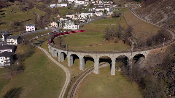 Train on Brusio Spiral Viaduct in Switzerland