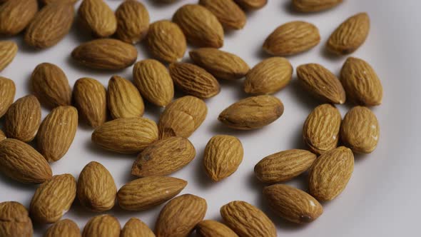 Cinematic, rotating shot of almonds on a white surface - ALMONDS 007