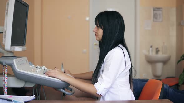 Echocardiography and Ultrasonography in the Doctor's Office Female Doctor Examining a Patient's