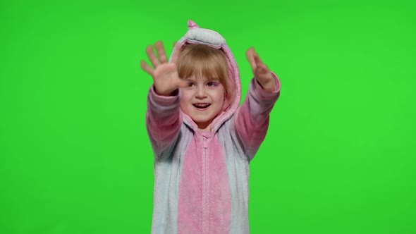 Little Child Girl Smiling Waving Greeting Hello or Bye with Hand in Unicorn Pajamas on Chroma Key