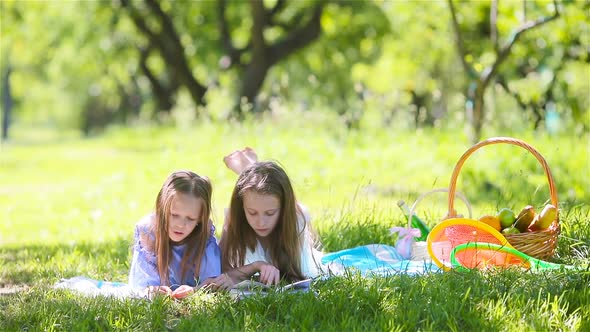 Two Little Kids on Picnic in the Park