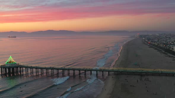 Sunset Over Manhattan Beach Pier Decorated With Lights During Christmas Season In California, USA. A