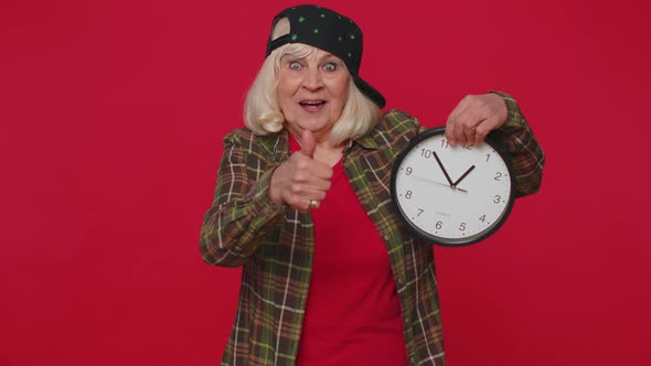 Elderly Senior Woman Showing Time on Clock Watch Ok Thumb Up Approve Pointing Finger at Camera