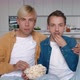 Two LGBTQ Men Watching Horror Movie Film on TV and Eating Popcorn at Home - VideoHive Item for Sale