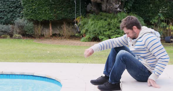 Worried young man sitting near pool 4K 4k