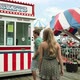 Teenage girl taking boyfriend to ticket booth in fun fair - VideoHive Item for Sale