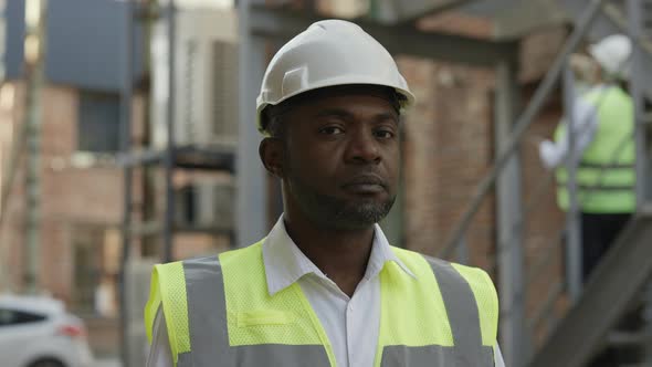 Portrait of Builder Looking at Camera with Calm Face Outdoor