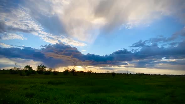 Sunset with heavy clouds over the field