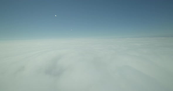 Shot from behind commercial plane, following small jet as it lands at airport, overcast day