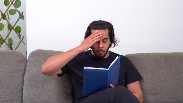 Shocked and surprised Indian man reading a diary