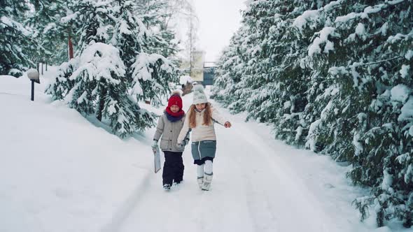 Children in Warm Clothes are Walking Along