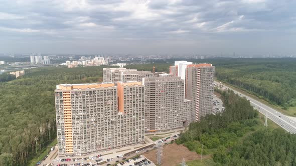 Aerial drone shot of apartment buildings next to the highway 06