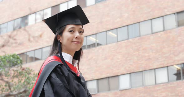 Cheerful woman with graduation gown