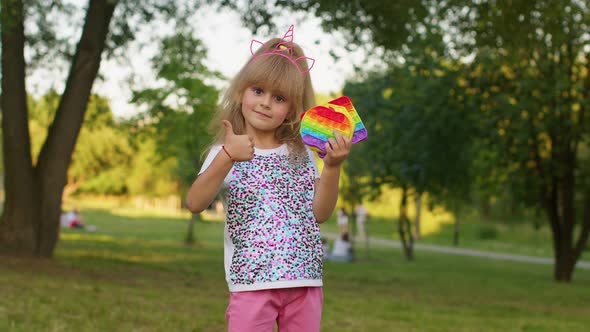 Child Girl Holding Many Colorful Squishy Silicone Bubbles Pop It Popular Sensory Toys Thumb Up