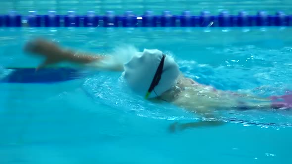 Professional Swimmer Practicing in Water Swimming Pool