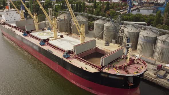 Loading Grain Into Sea Cargo Vessel in Seaport From Silos of Grain Storage