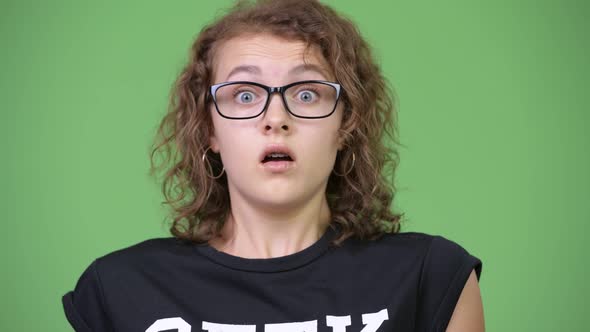 Young Beautiful Nerd Woman Looking Shocked While Covering Mouth