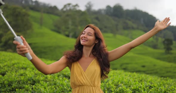Selfie on Smartphone of Traveler Woman During Her Travel on Famous Nature Landmark Tea Plantations
