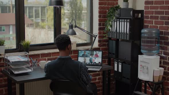 Accountant Talking to Colleagues on Online Video Call in Office