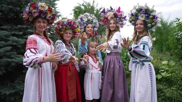 Group of Graceful Beautiful Ukrainian Women and Girl Standing in Park Looking at Camera Stretching