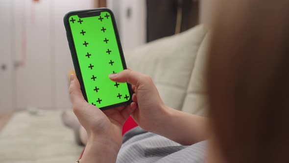 Closeup Woman Hand Using Smart Phone with Green Screen