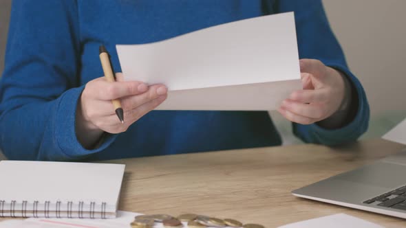 Female Hands Opening Envelope Letter Document or Bills Reading Writing Down