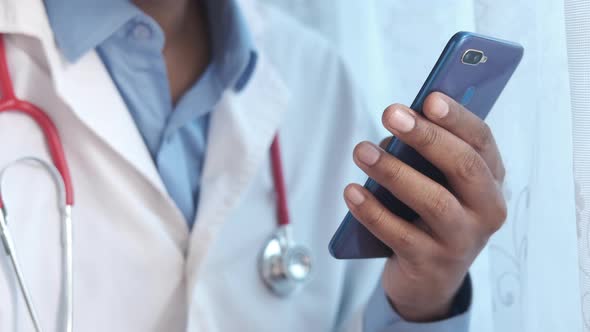 Doctor in White Coat Using a Smartphone