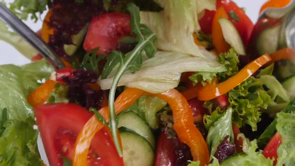 Fresh Mixed Vegetables Falling Into Bowl of Salad Isolated on White. Slow Motion.