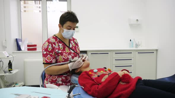 Dentist working on her patient's teeth