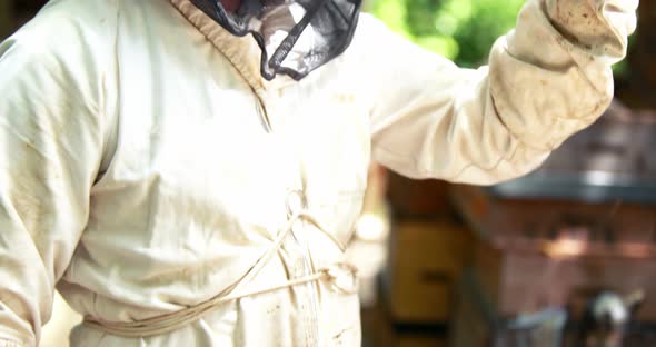 Beekeeper holding a bottle of honey