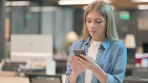 Young Woman BRowsing Internet on Smartphone