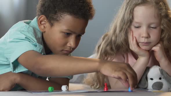 Male and Female Kids Lying on Sofa, Playing Board Game, Recreational Activity