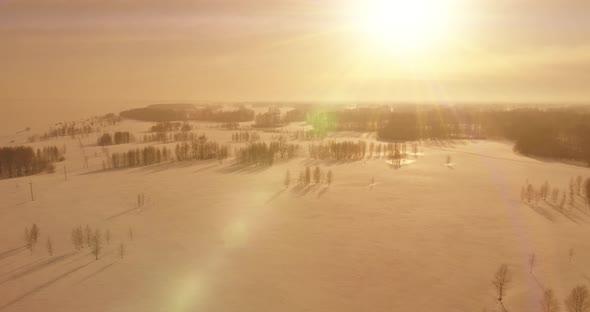 Aerial View of Cold Winter Landscape Arctic Field Trees Covered with Frost Snow Ice River and Sun