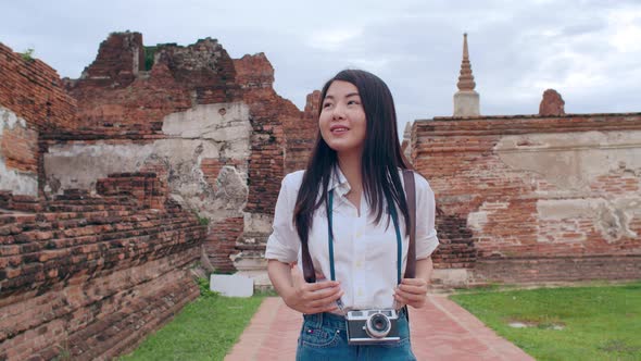 Japanese backpacker female enjoy her journey at amazing landmark in traditional city.