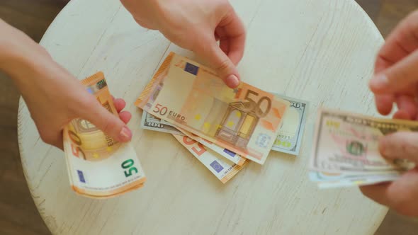 Hands Counting Euro Pound and Dollars Banknotes