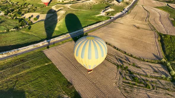 4K Aerial view of Goreme. Colorful hot air balloons fly over the valleys.