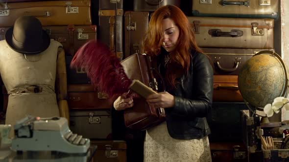 Young Shopkeeper Standing with Vintage Suitcases in Her Hand Portrait in Her Vintage Suitcases Shop