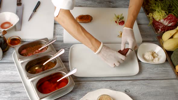 Hands Put Pear on Plate.