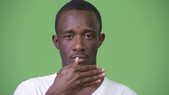 Young African Man Covering Eyes As Three Wise Monkeys Concept