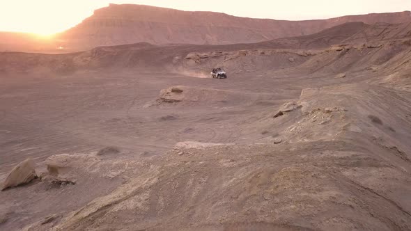 OHV winding through the desert at sunset