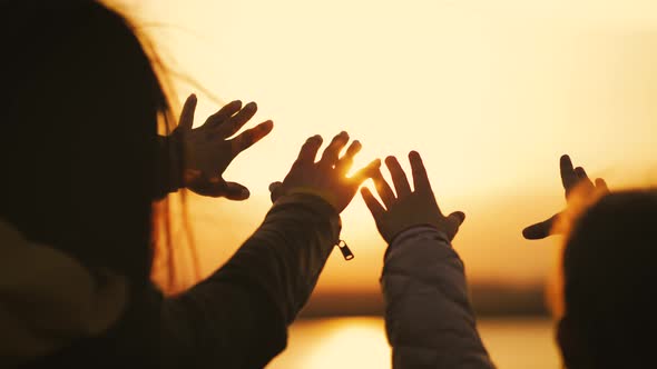 Silhouette of Reaching Helping Hand Hope and Support Each Other Over Sunset