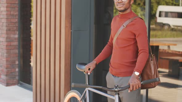 Portrait of Young African-American Man with Bike at Downtown