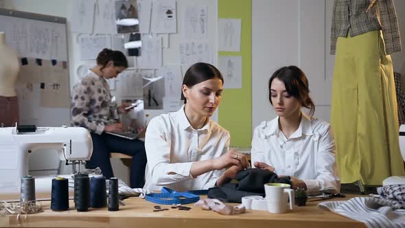 Two Attractive Young Woman Working in the Sew Studio