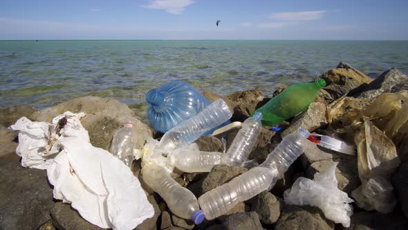 Dirty Plastic Bottles on the Stone Beach