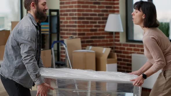 Married Couple Decorating Apartment with Furniture to Move in