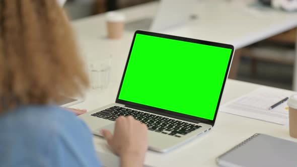 African Woman Using Laptop with Green Chroma Key Screen