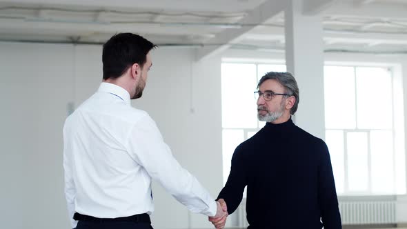 Realtor Man Meets with Businessman to Discuss Rent and Shake Hands Side View