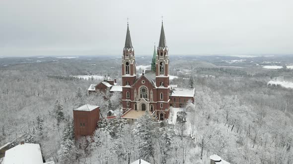 Large historic church building on mountain in the winter.