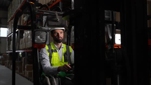 Bearded Forklift Driver During Work in Warehouse
